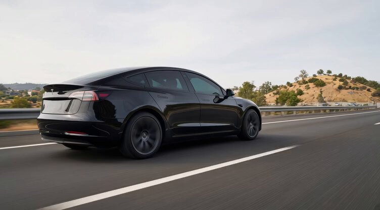 Cool Black Tesla Driving on Highway