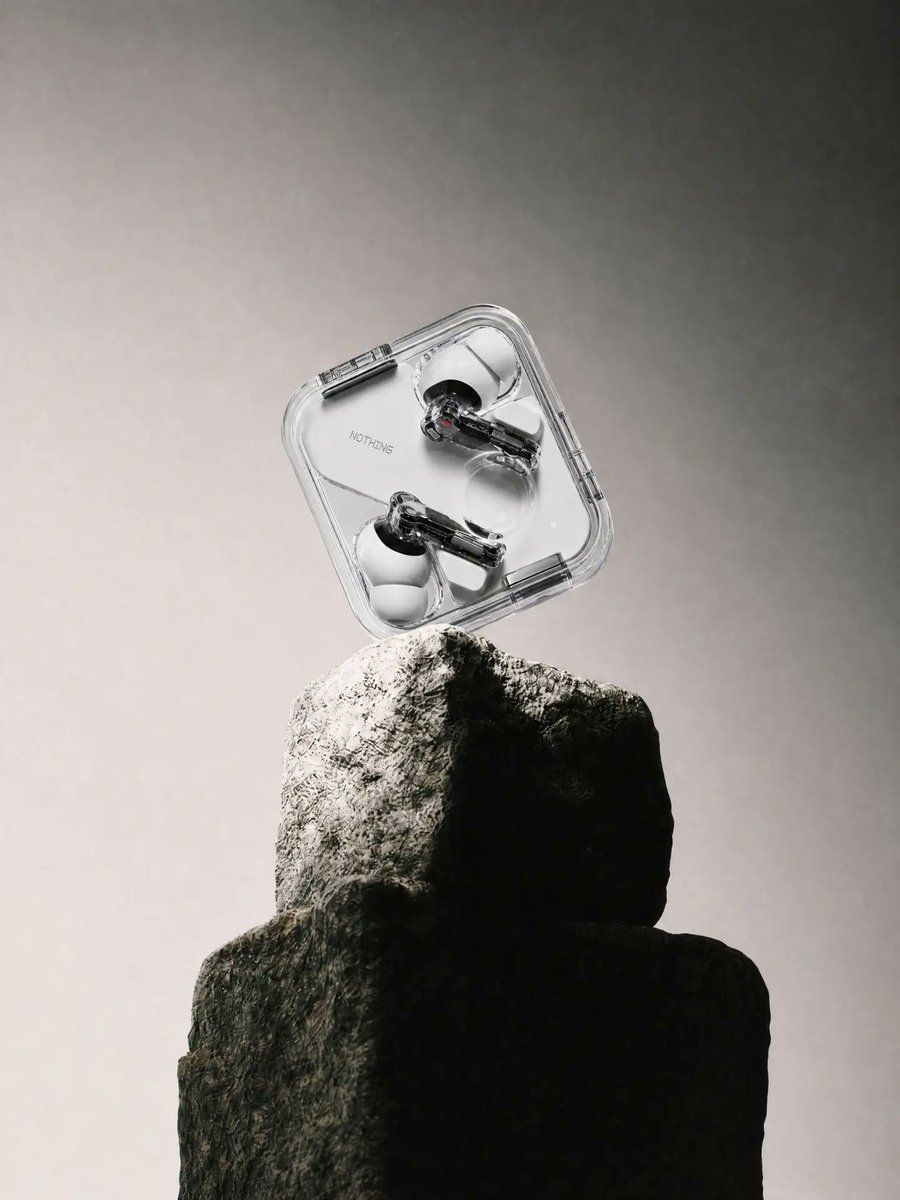 Transparent Earbuds on Stone Pedestal